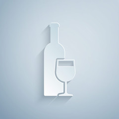 Paper cut Wine bottle with wine glass icon isolated on grey background. Paper art style. Vector Illustration