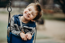 Portrait Of A Happy Little Boy At The Playground