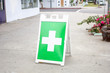 A general white and green cross symbol indicating a nearby marijuana dispensary