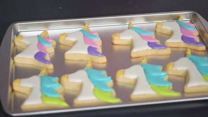 Poster - Decorating unicorn sugar cookies with multi-color royal icing.