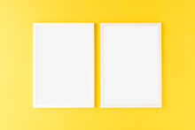 Two Empty Photo Frames Hanging On Yellow Wall. Mockup