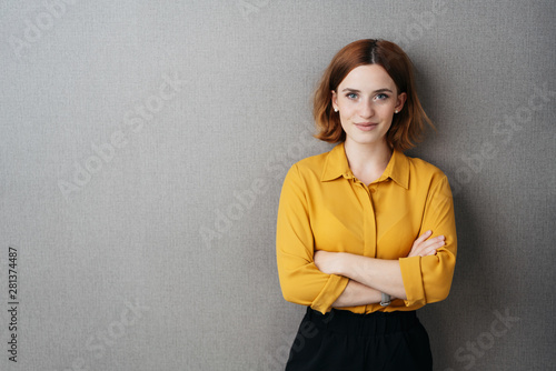 Friendly confident young woman over grey Tableau sur Toile