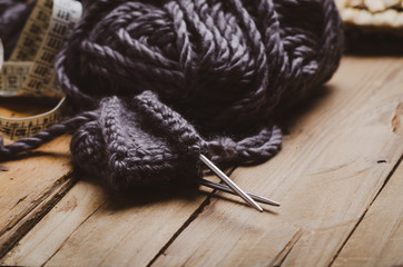 Ball of wool yarn  on a wooden background. Home hobbies, knitting. Cozy comfort concept