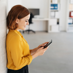 Young businesswoman smiling at a text message