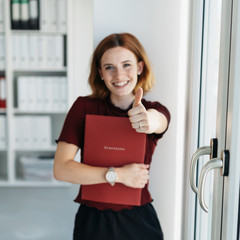 Happy young woman signalling her success