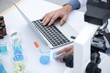 © chokniti - using laptop for working in laboratory