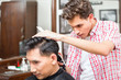 © Kzenon - Hairdresser cutting hair with trimmer