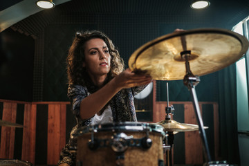 Wall Mural - Woman playing drums during music band rehearsal