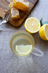 Wall Mural - Glass of hot water, lemon and honey, the perfect cold remedy. 