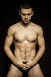© Oleh Phoenix - Strong stripped muscle male model in underwear on black isolated font background