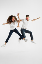 Beautiful Young Couple Celebrating Red Nose Day Isolated On White Studio Background. Facial Expression, Human Emotions, Ad Concept. Copyspace. Woman And Man Jumping, Dancing Or Running Together.