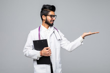 Handsome Indian Man Doctor Presenting Something Standing Isolated Over Blue Background
