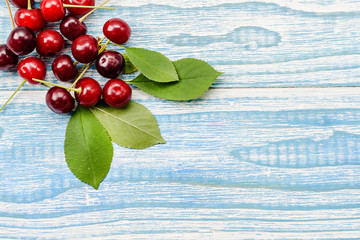 Natural garden cherry berries on a wooden background - the concept of natural grown products