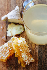 Wall Mural - Close up of honey, ginger and lemons ingredients for a hot tea that's a natural cold remedy