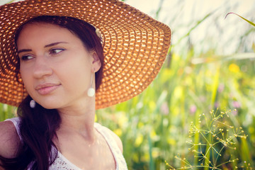 portrait of young woman in straw hat