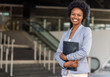 Female African American job seeker keeping a folder with CV