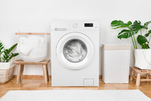 Modern Washing Machine, Laundry In Baskets And Domestic Room Interior