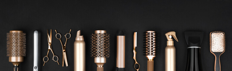 Collection of professional hair dresser tools arranged on dark background