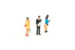 © Sean - Miniature People Looking at Media/Newspaper/Phone Standing on a White Isolated Background