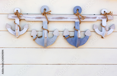 Small Decorative Grappling Hooks On White Wooden Background