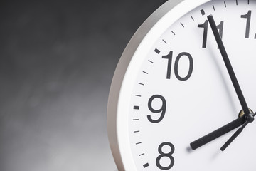 Close-up of clock face against gray background