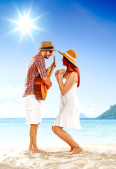 Poster - Happy woman and man having fun on the beach on sunny summer day.