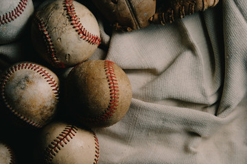 Sticker - Old rough and rugged baseballs with used ball glove on canvas background for sports game concept.