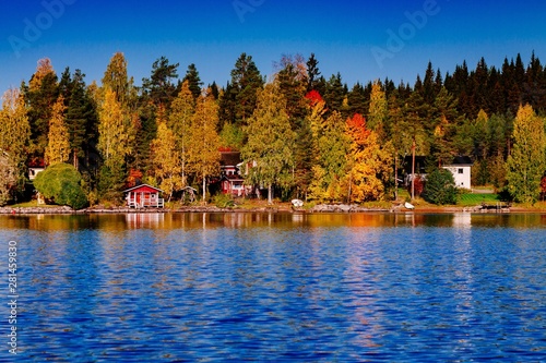 Autumn Foliage Fall Colorful Forest Over Blue Lake With Red