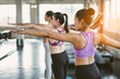 © Yingyaipumi - Group of young asian women sporty attractive people practicing yoga lesson with instructor, standing or sitting together in gym.Female friends are doing yoga exercise,working out,studio background.
