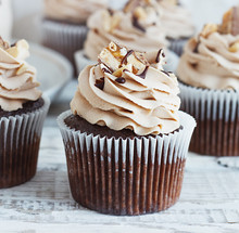 Chocolate Cupcake With Mousse Cream Icing On Grunge White Wooden Background Copy Space
