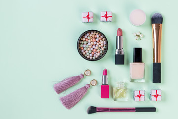 Flat lay composition with makeup products on light green background.set of professional decorative cosmetics, makeup tools and accessory. beauty, fashion and shopping concept.Beauty flat lay