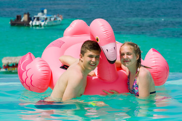 Canvas Print - Caucasian teenagers playing in infinity swimming pool in luxury hotel, Punta Cana, Dominican Republic. Summer vacation concept