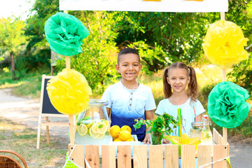 Poster - Cute little children at lemonade stand in park