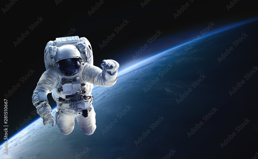 Astronaut in the outer space over the planet Earth. Abstract wallpaper. Spaceman. Black bakground. Elements of this image furnished by NASA - obrazy, fototapety, plakaty 