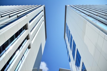 modern office building with blue sky and clouds