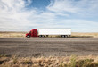 © Mint Images - Commercial truck driving on desert road