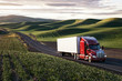© Mint Images - Commercial truck driving though farmland