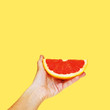 © liza - Grapefruit in hand on a bright background. Modern art collage