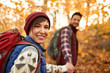 © AYAimages - Attractive caucasian couple hiking through the forest in the fall in Canada
