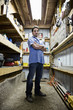 © Mint Images - Portrait of worker standing indoors