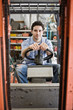 © Mint Images - Portrait of worker driving forklift truck