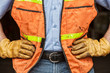 © Mint Images - Midsection of worker wearing protective clothing and glove