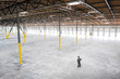 © Mint Images - Owner checking out interior of empty warehouse space