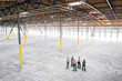 © Mint Images - People standing in warehouse