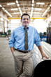 © Mint Images - Portrait of smiling manager standing in factory