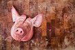 © Mint Images - Close up of slaughtered pig's head on wooden block