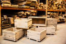 Shelves With Wooden Planks And Stack Of Wooden Crates In Warehouse
