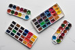 © LIGHTFIELD STUDIOS - top view of colorful paint palettes on marble white surface