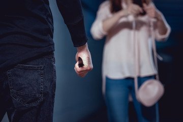 Wall Mural - selective focus of thief with knife standing near woman