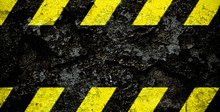 Warning Danger Sign Yellow And Black Stripes Pattern With Black Area Over Concrete Cement Wall Facade Peeling Cracked Paint. Wide Panorama Background Do Not Enter The Area, Caution, Danger, Hazard.
